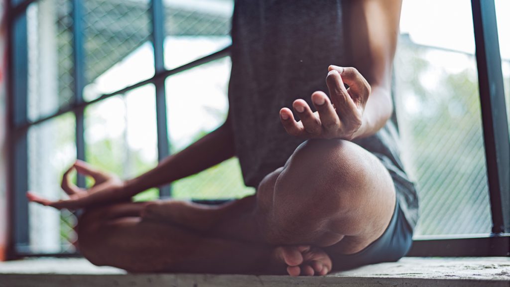 Man practicing meditation and showing his mental balance and healthy lifestyle